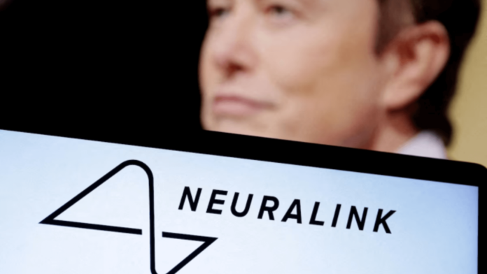 Logo Neuralink hiển thị trên màn hình một chiếc laptop, đằng sau là hình ảnh Elon Musk. Ảnh: Reuters